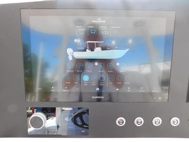 Slide: The Image of 2024 Regulator 30XO boat dashboard with Garmin display and control panel. - 26