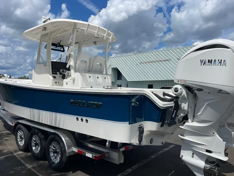 Slide: The Image of 2024 Regulator 30XO boat with Yamaha engine on a trailer under a cloudy sky. - 3