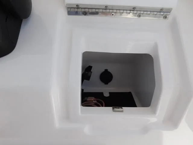 Slide: The Image of 2024 Regulator 30XO boat compartment with open hatch and visible interior details. - 34