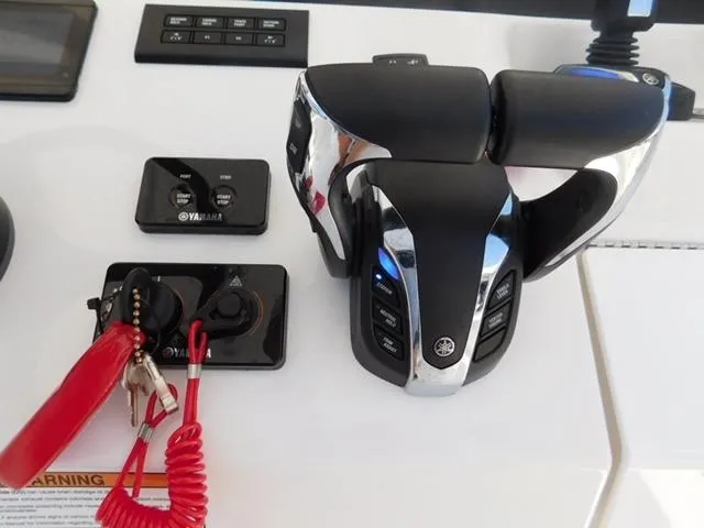 Slide: The Image of 2024 Regulator 30XO boat controls with Yamaha throttle and safety lanyard. - 35