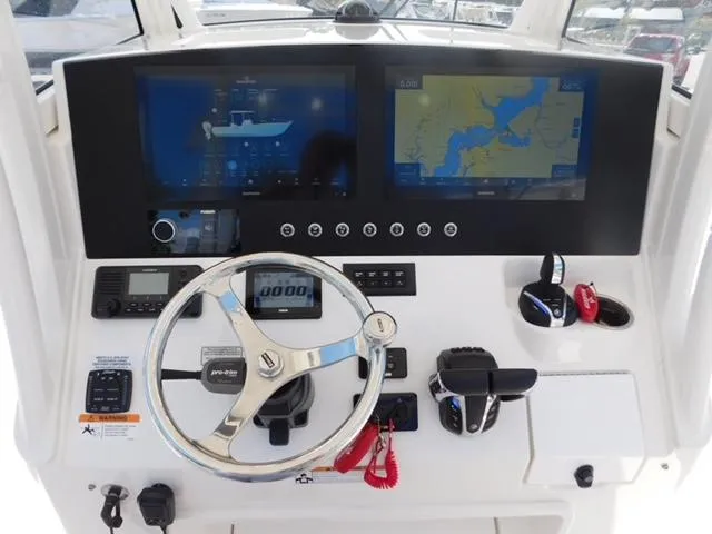 Slide: The Image of 2024 Regulator 30XO boat dashboard with dual screens and steering wheel. - 39