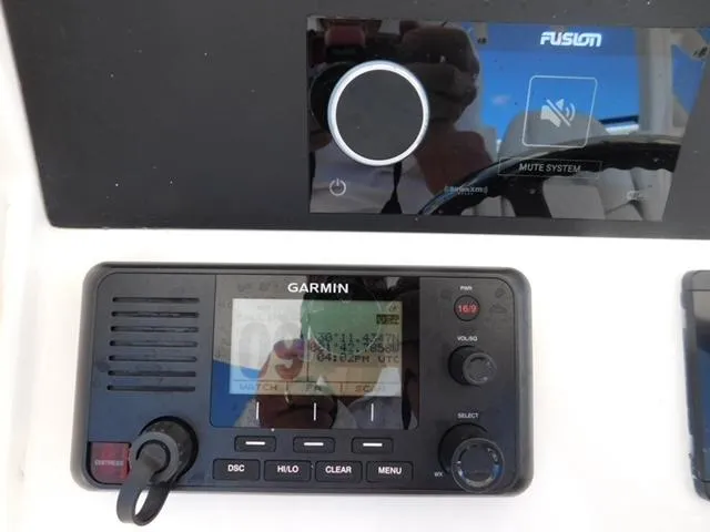 Slide: The Image of Garmin marine radio and Fusion audio system on 2024 Regulator 30XO boat dashboard. - 40