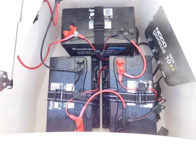 Slide: The Image of 2024 Regulator 30XO boat battery compartment with multiple marine batteries and charger. - 42