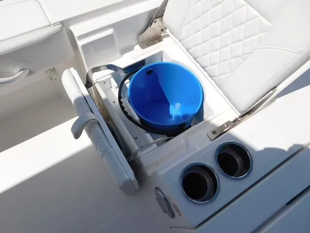 Slide: The Image of 2024 Regulator 30XO boat seat with storage, blue bucket, and cup holders. - 44
