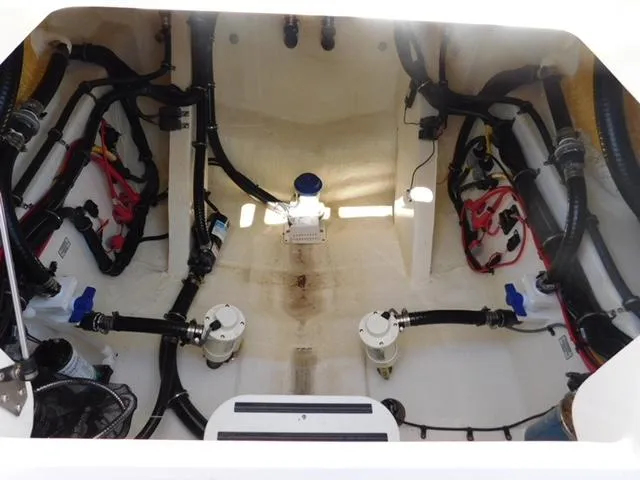 Slide: The Image of 2024 Regulator 30XO boat interior showing wiring and plumbing systems. - 46