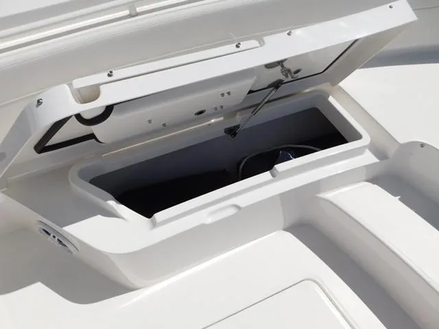 Slide: The Image of 2024 Regulator 30XO boat storage compartment open, showcasing interior space. - 49