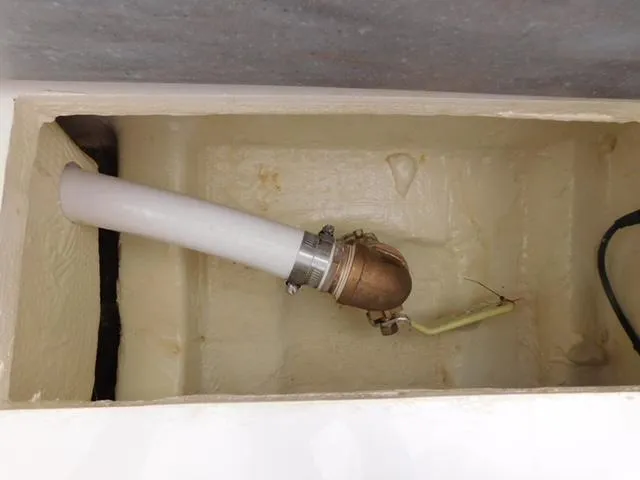 Slide: The Image of 2024 Regulator 30XO boat component with white hose and brass fitting in compartment. - 5