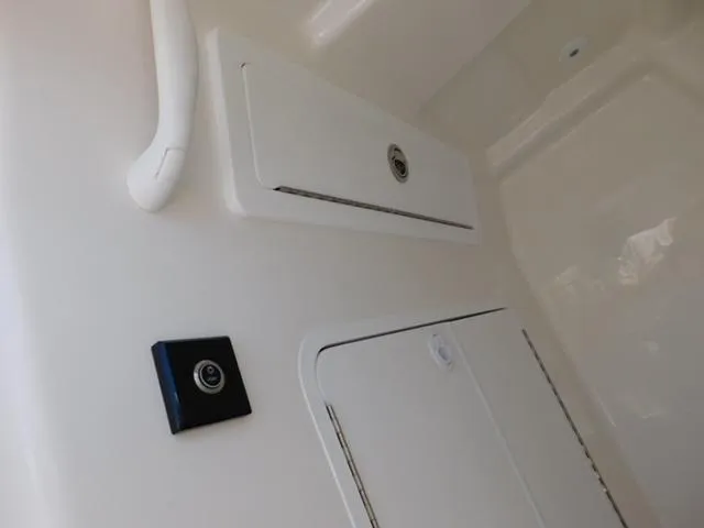 Slide: The Image of 2024 Regulator 30XO interior compartment with sleek white finish and secure storage. - 8