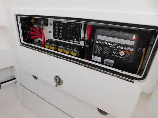 Slide: The Image of 2024 Regulator 30XO electrical panel with SeaStar DCM battery and wiring components. - 9