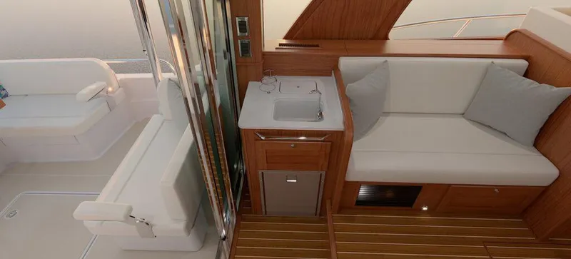 Slide: The Image of 2027 Sabre 51 Salon Express yacht kitchen with wood cabinetry, stainless appliances, and elegant decor. - 13