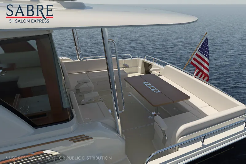 Slide: The Image of 2027 Sabre 51 Salon Express yacht interior with people relaxing on deck. - 4