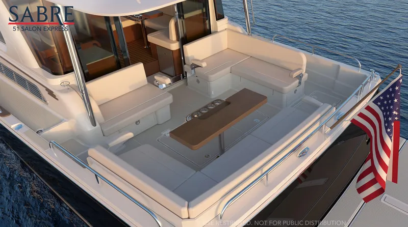 Slide: The Image of Couple relaxing on 2027 Sabre 51 Salon Express yacht, enjoying sunny day on the water. - 5