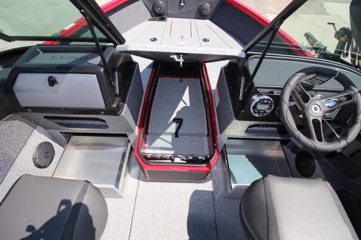 Slide: The Image of 2025 Lund 1875 Impact XS Sport boat interior with steering wheel and storage compartments. - 10