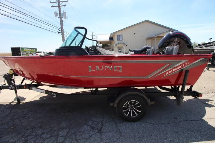 Slide: The Image of 2025 Lund 1875 Impact XS Sport boat in vibrant red on a trailer. - 2