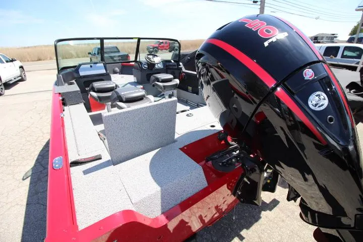Slide: The Image of 2025 Lund 1875 Impact XS Sport boat with powerful outboard motor, red and gray interior. - 4