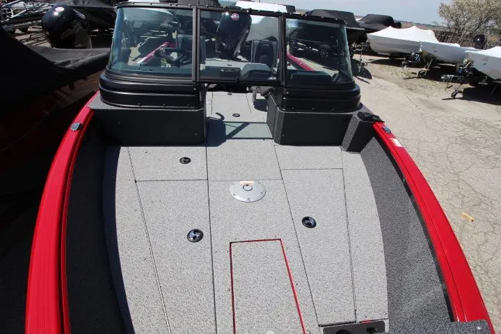 Slide: The Image of 2025 Lund 1875 Impact XS Sport boat with red trim and spacious deck. - 6