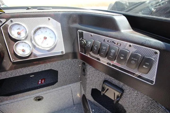 Slide: The Image of Dashboard of 2025 Lund 1875 Impact XS Sport boat with gauges and control panel. - 8