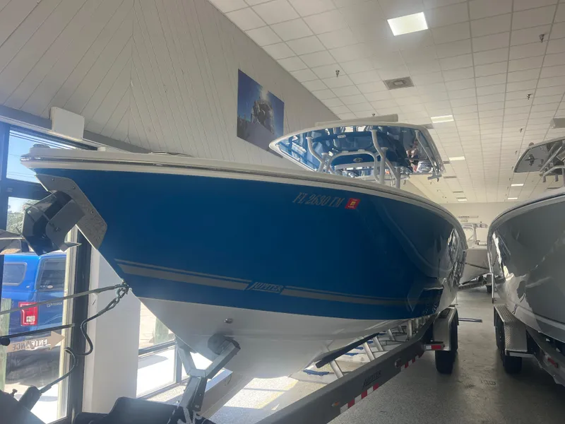 The Image of 2022 Jupiter 34 FS boat in showroom, blue hull, on trailer. - 1