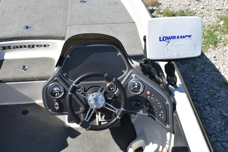 Slide: The Image of 2011 Ranger Z521 Comanche boat dashboard with steering wheel and Lowrance GPS system. - 11