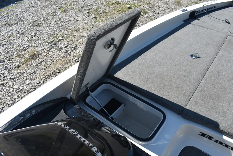 Slide: The Image of 2011 Ranger Z521 Comanche boat storage compartment open on gravel surface. - 16