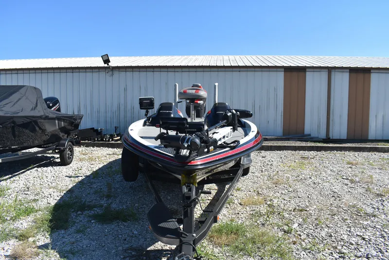 Slide: The Image of 2011 Ranger Z521 Comanche boat parked on gravel near a storage building. - 5