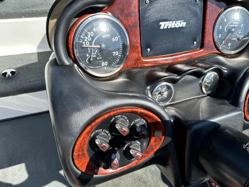 Slide: The Image of Dashboard of a 2004 Triton Tr-20XDC boat with speedometer and controls. - 18