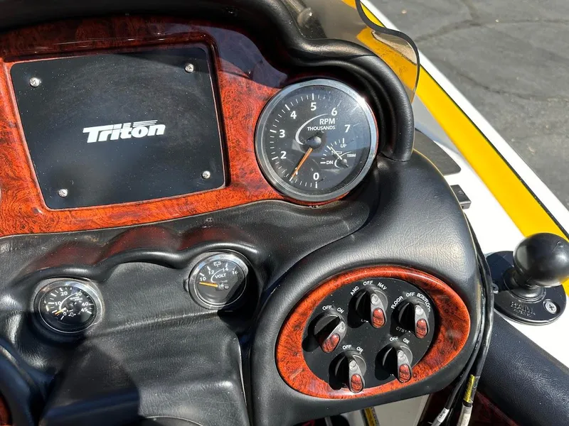 Slide: The Image of Dashboard of a 2004 Triton Tr-20XDC boat with gauges and controls. - 19