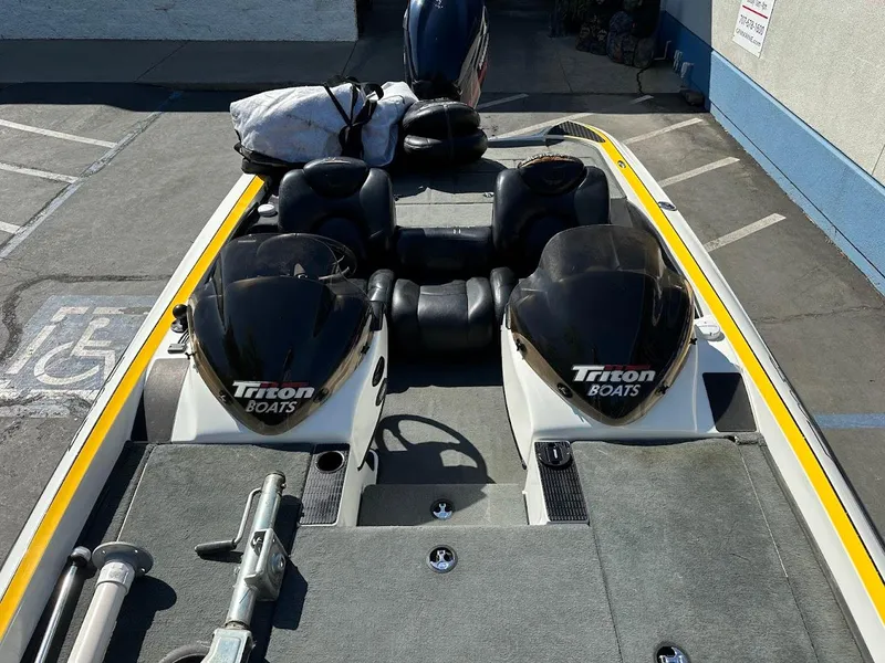 Slide: The Image of 2004 Triton Tr-20XDC boat with dual consoles and seating, parked in a lot. - 27