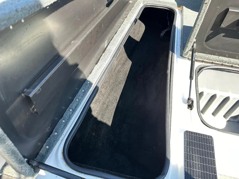 Slide: The Image of Open storage compartment in a 2004 Triton Tr-20XDC boat. - 29