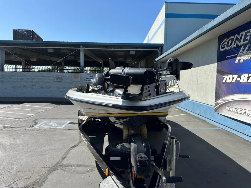 Slide: The Image of 2004 Triton Tr-20XDC boat parked outside a building on a sunny day. - 3