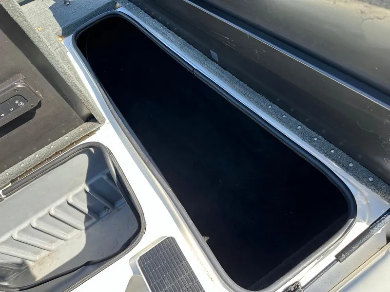 Slide: The Image of Open storage compartment in a 2004 Triton Tr-20XDC boat. - 30