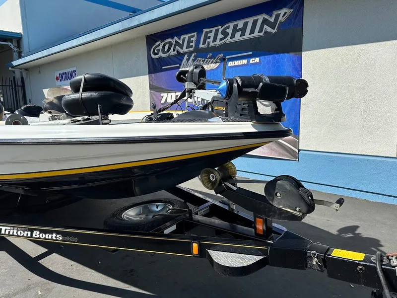 Slide: The Image of 2004 Triton Tr-20XDC boat on trailer outside "Gone Fishin'" store. - 4