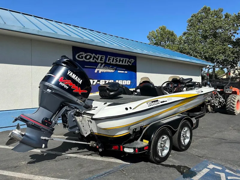 Slide: The Image of 2004 Triton Tr-20XDC boat with Yamaha VMAX engine parked outside a fishing store. - 7