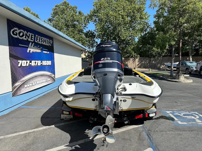 Slide: The Image of 2004 Triton Tr-20XDC boat with powerful outboard motor in parking lot. - 8