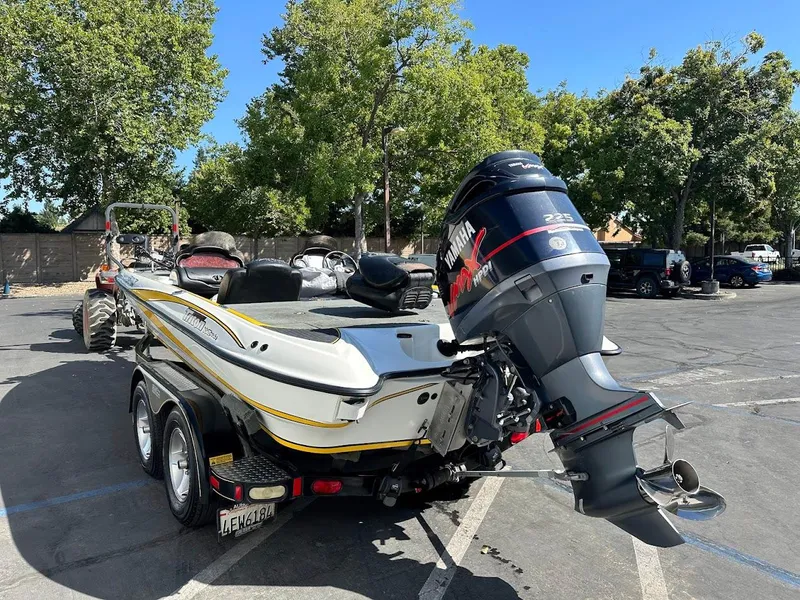 Slide: The Image of 2004 Triton Tr-20XDC boat with Yamaha outboard motor in a parking lot. - 9