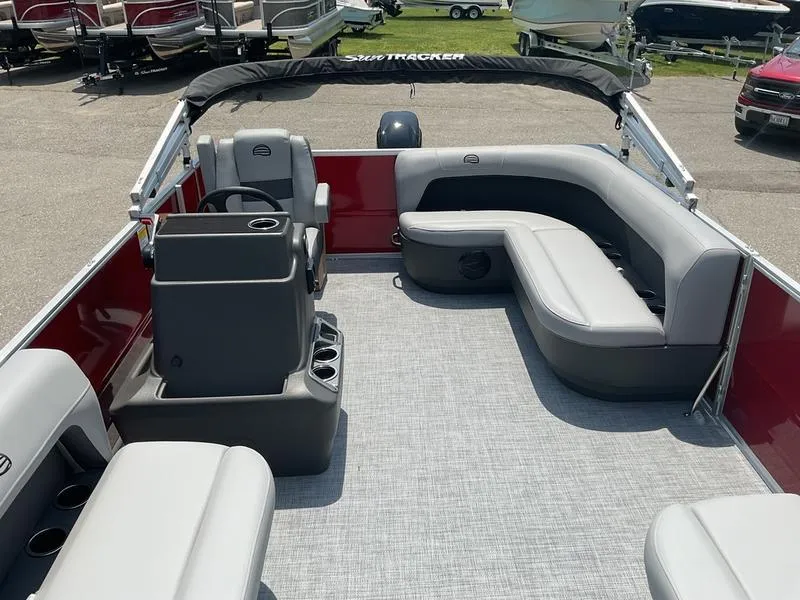 Slide: The Image of 2026 Sun Tracker PB 16 DLX pontoon boat interior with gray seating and red accents. - 13