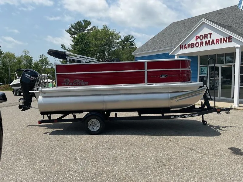 Slide: The Image of 2026 Sun Tracker PB 16 DLX pontoon boat at Port Harbor Marine dealership. - 3