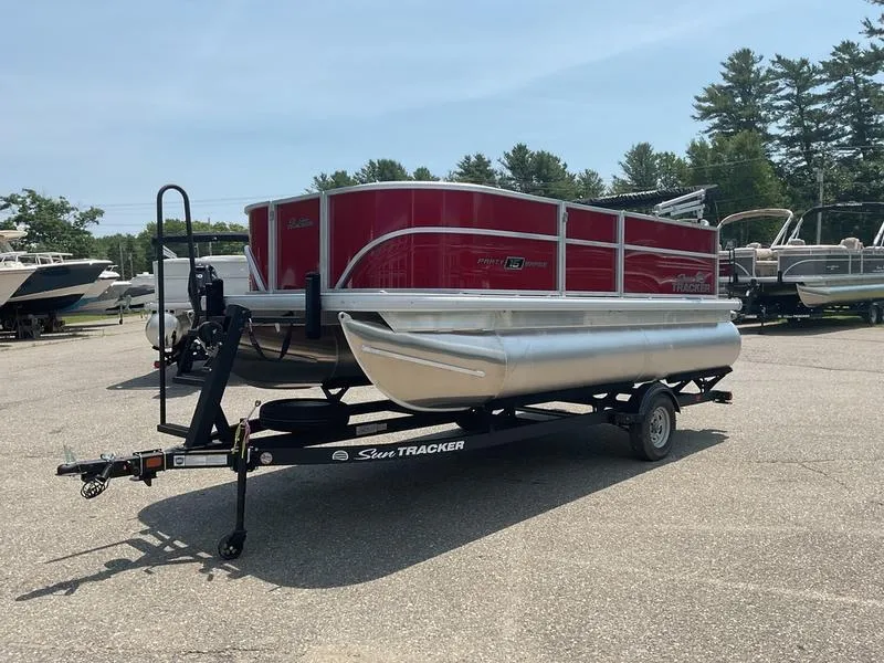 Slide: The Image of 2026 Sun Tracker PB 16 DLX pontoon boat on trailer in outdoor lot. - 6