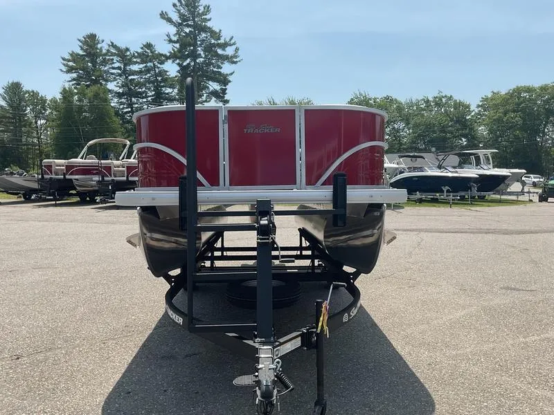 Slide: The Image of 2026 Sun Tracker PB 16 DLX pontoon boat on trailer, parked outdoors. - 7
