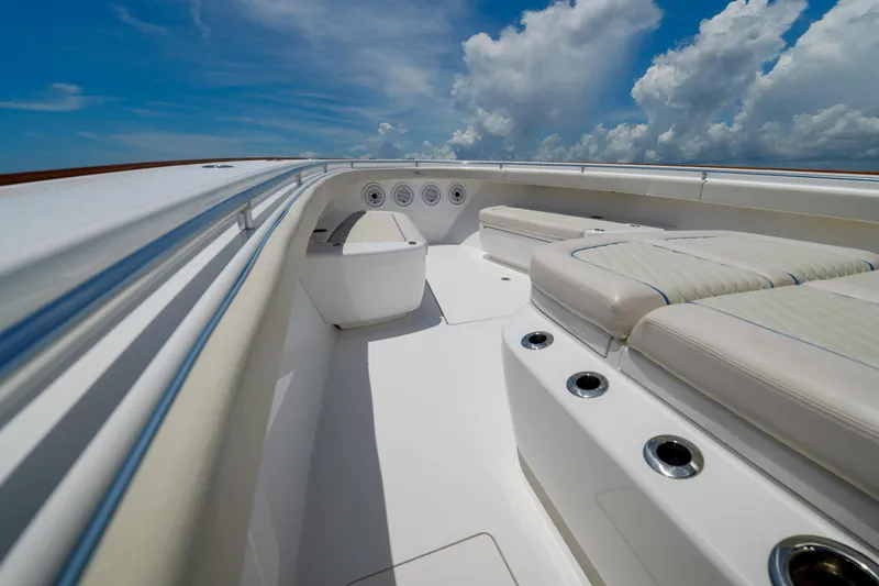 Slide: The Image of 2022 Valhalla Boatworks V41 interior with cushioned seating and clear blue sky. - 12