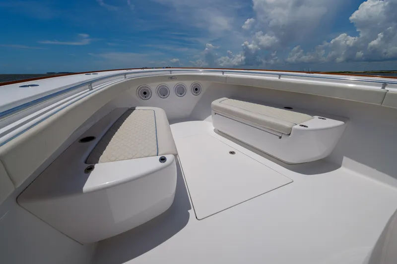 Slide: The Image of 2022 Valhalla Boatworks V41 interior with cushioned seating under a clear blue sky. - 13