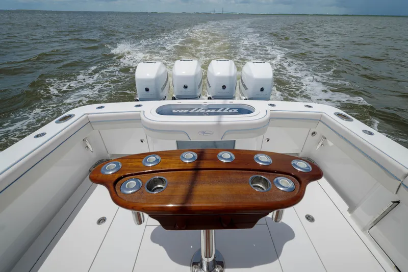 Slide: The Image of 2022 Valhalla V41 boat with four engines, wooden table, cruising on open water. - 15