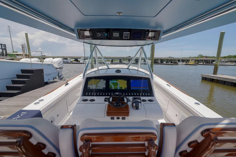 Slide: The Image of 2022 Valhalla Boatworks V41 helm with advanced navigation system, docked at marina. - 18