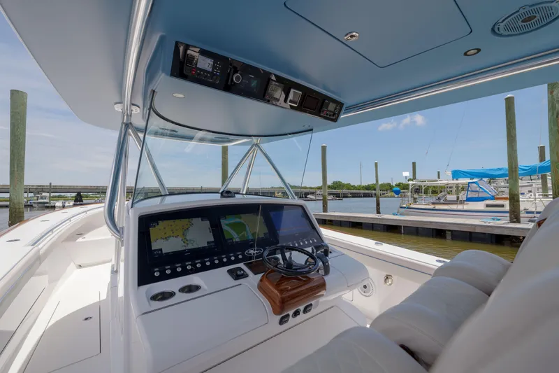 Slide: The Image of 2022 Valhalla Boatworks V41 helm with advanced navigation systems at a marina. - 19