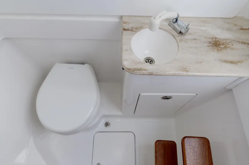 Slide: The Image of 2022 Valhalla V41 boat bathroom with toilet, sink, and wooden accents. - 29