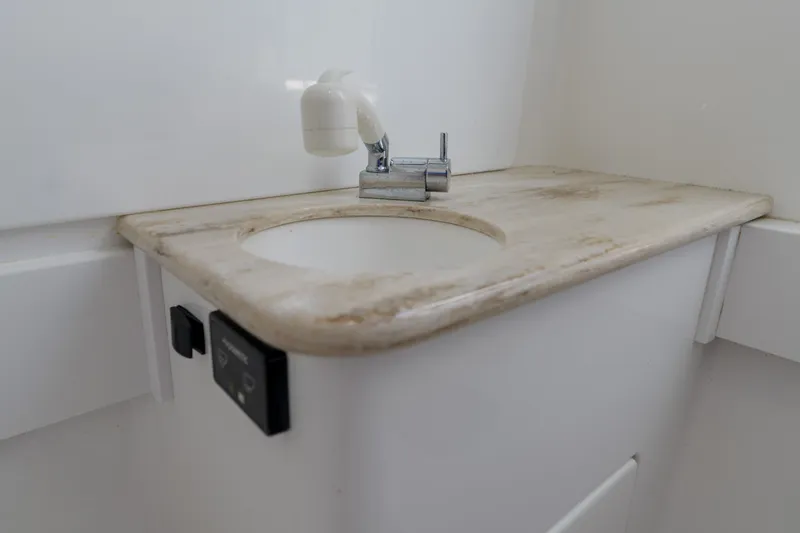 Slide: The Image of 2022 Valhalla Boatworks V41 bathroom sink with faucet and control panel. - 30