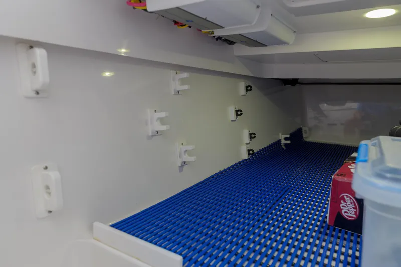 Slide: The Image of Interior storage compartment of 2022 Valhalla Boatworks V41 with blue mat and beverage box. - 31
