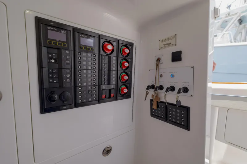 Slide: The Image of Electrical control panel on 2022 Valhalla Boatworks V41, featuring switches and keys. - 32