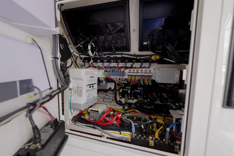 Slide: The Image of Electrical system inside 2022 Valhalla Boatworks V41, featuring organized wiring and Garmin equipment. - 33