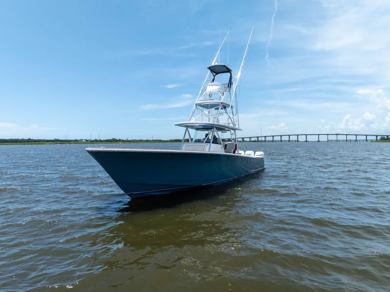 Slide: The Image of 2022 Valhalla Boatworks V41 on water with bridge in background under clear sky. - 4